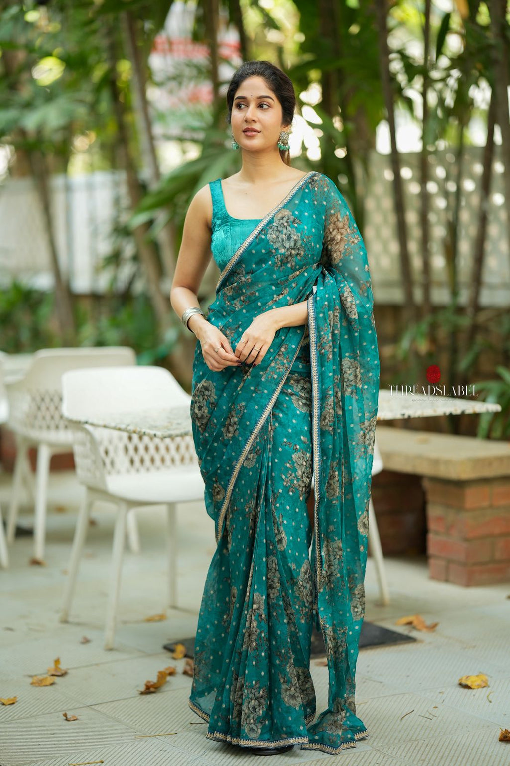 Peacock blue organza saree with velvet blouse