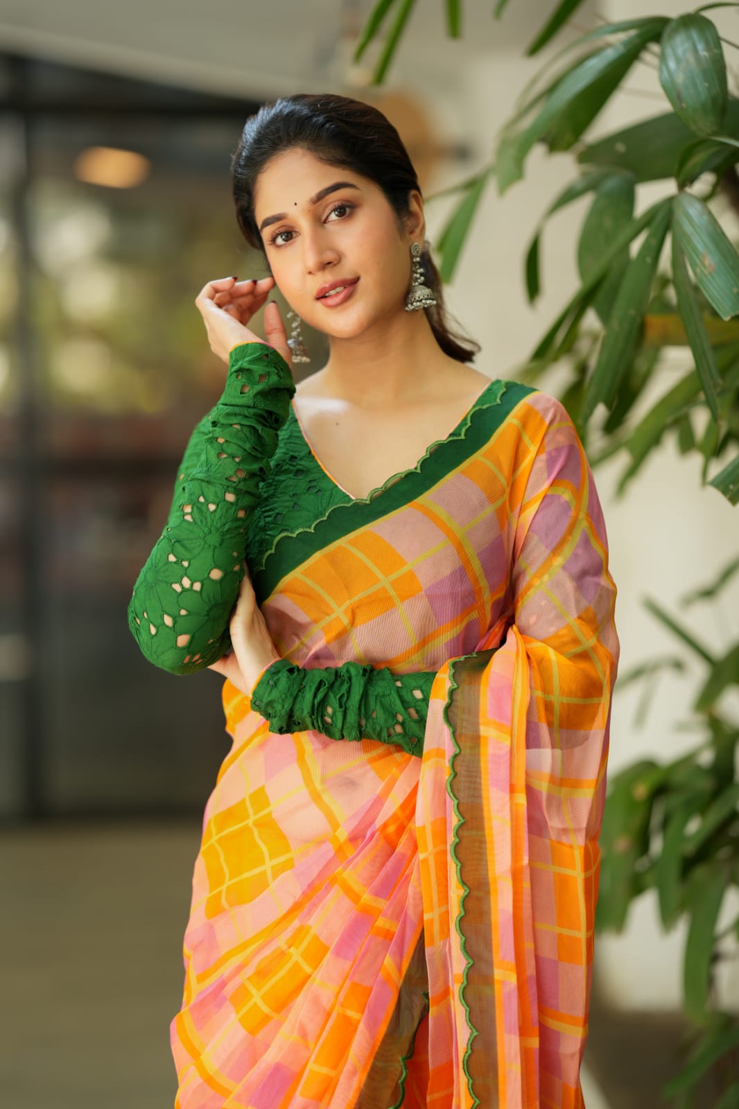 Orange viscose jute saree with green hakoba blouse