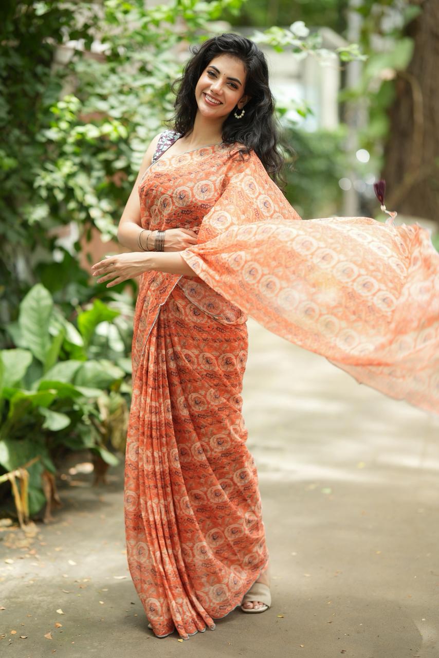 Pastel peach chiffon saree with brown hand work blouse