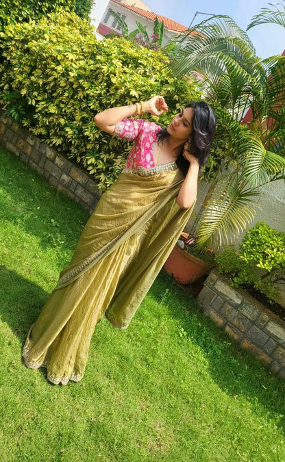 Green soft tissue saree with pink floral embroidered blouse