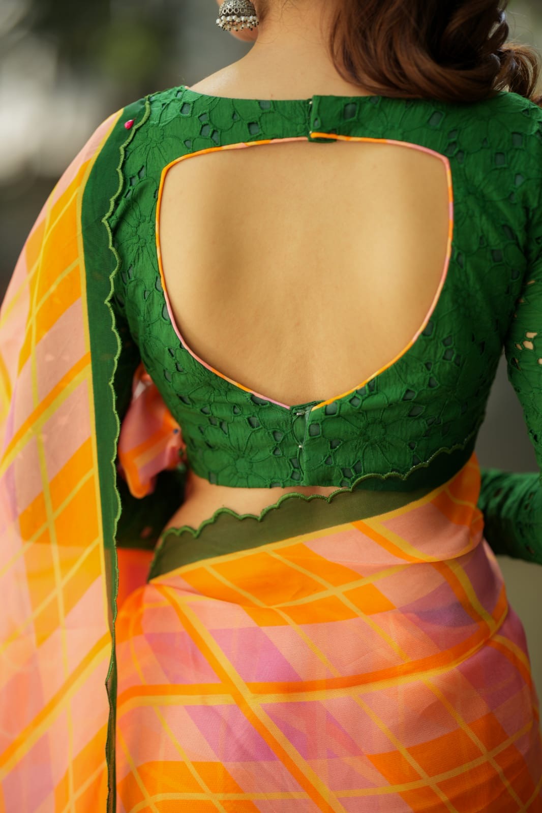 Orange viscose jute saree with green hakoba blouse