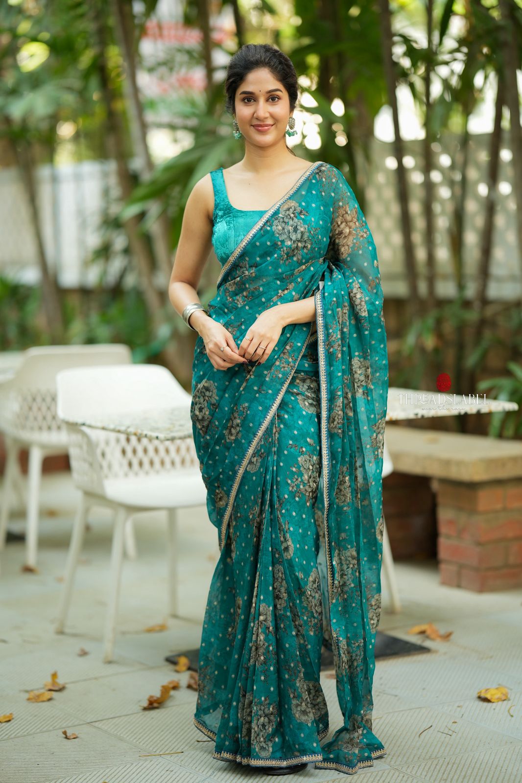 Peacock blue organza saree with velvet blouse