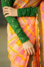 Orange viscose jute saree with green hakoba blouse