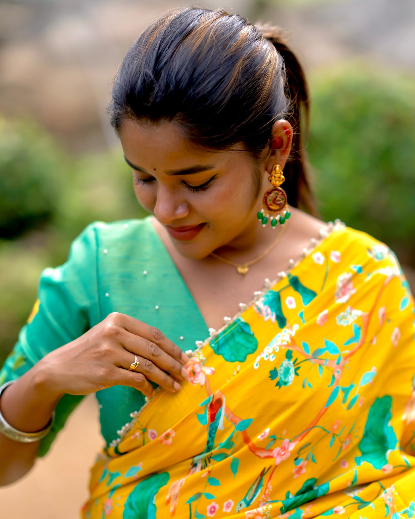 Yellow floral saree with green hand worked blouse