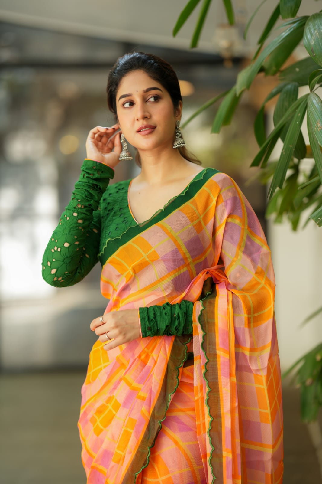 Orange viscose jute saree with green hakoba blouse
