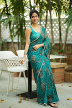 Peacock blue organza saree with velvet blouse