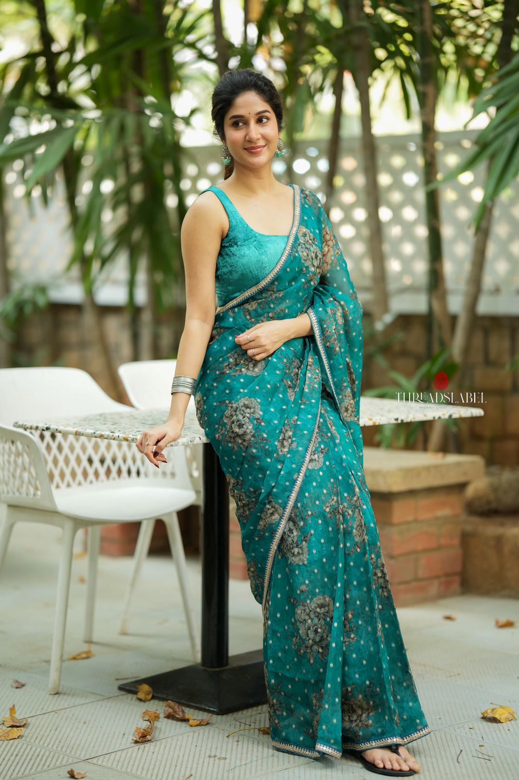Peacock blue organza saree with velvet blouse