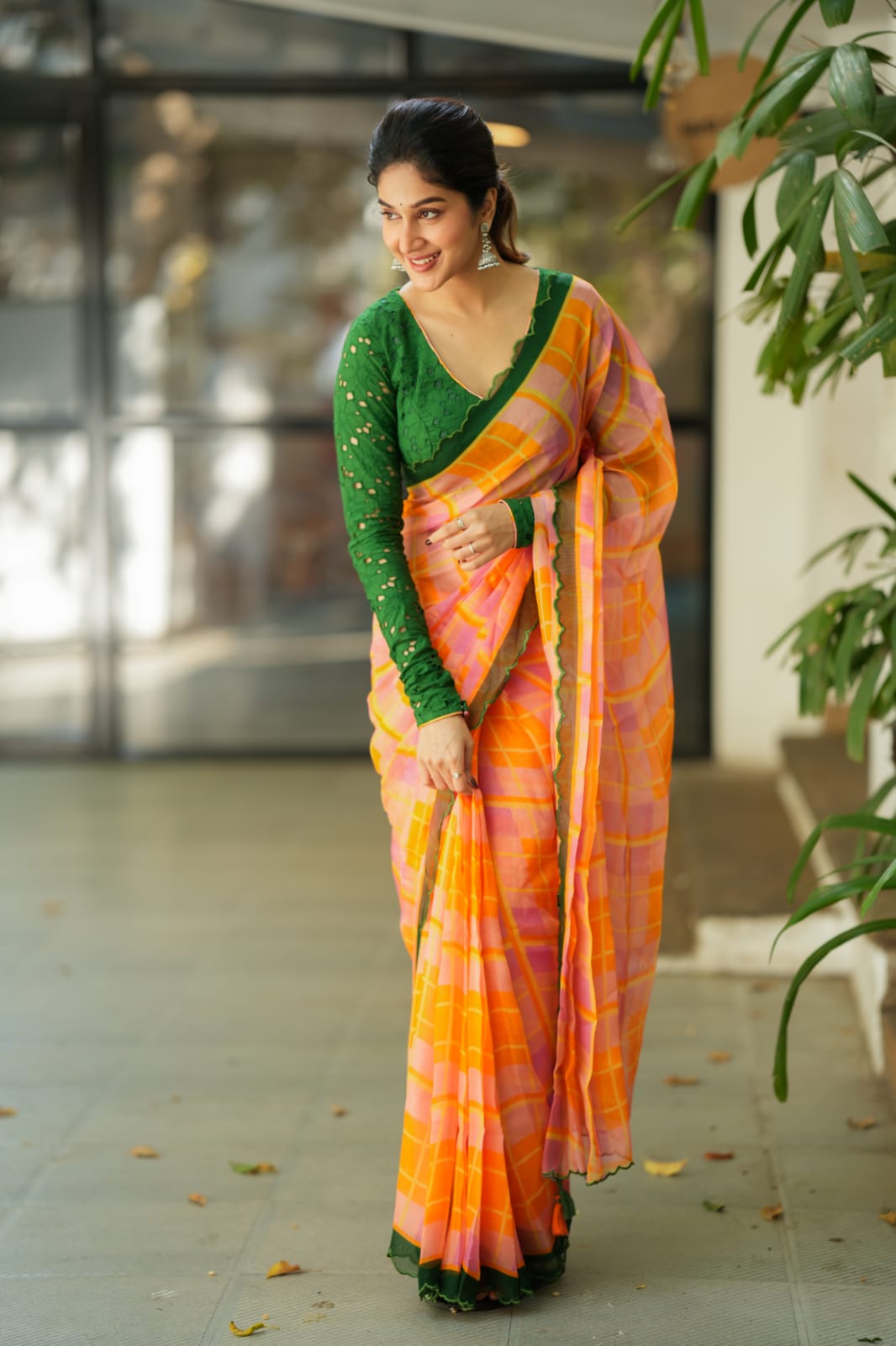Orange viscose jute saree with green hakoba blouse