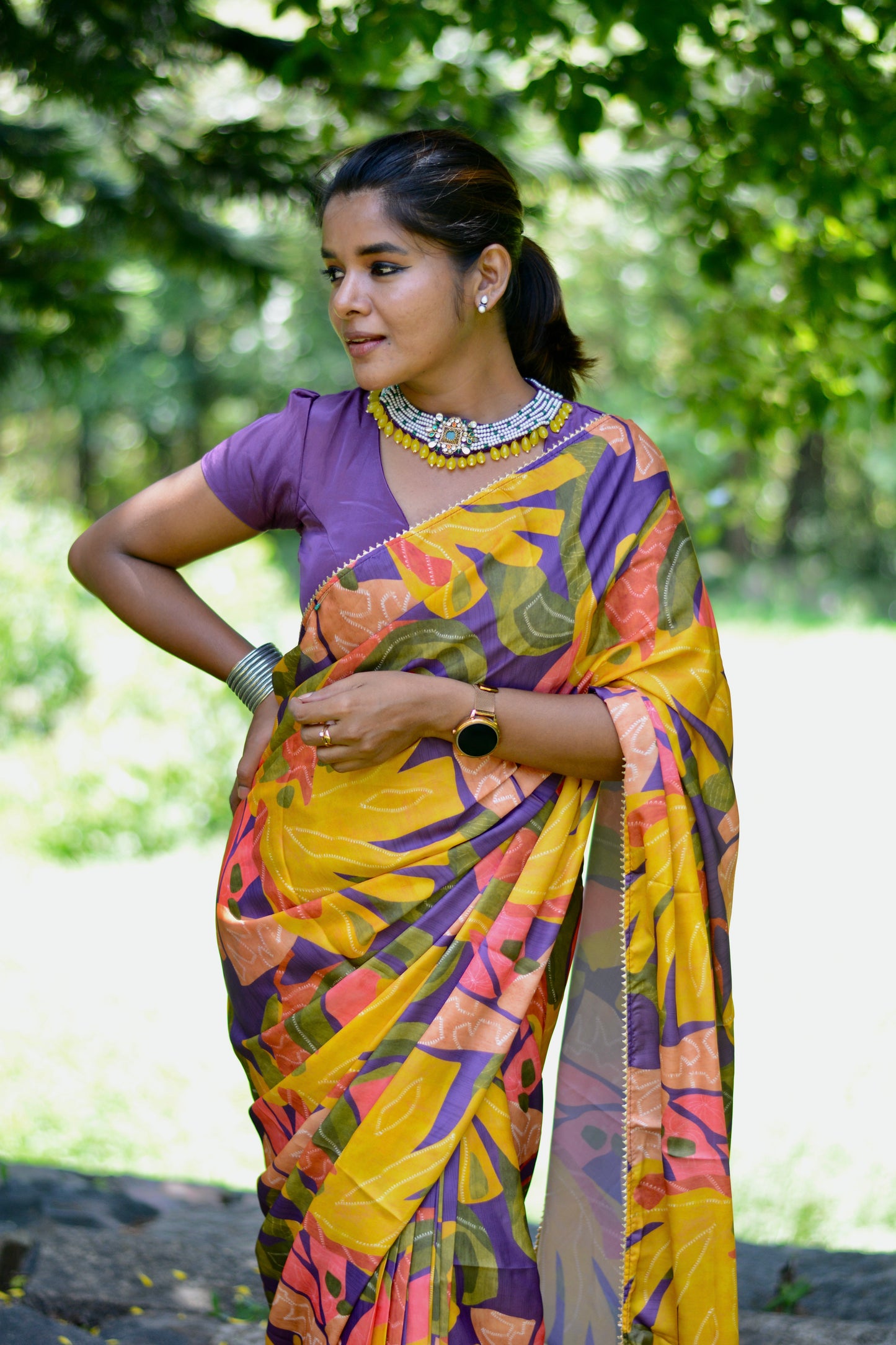 Yellow floral satin saree with purple jewel neck hand work blouse