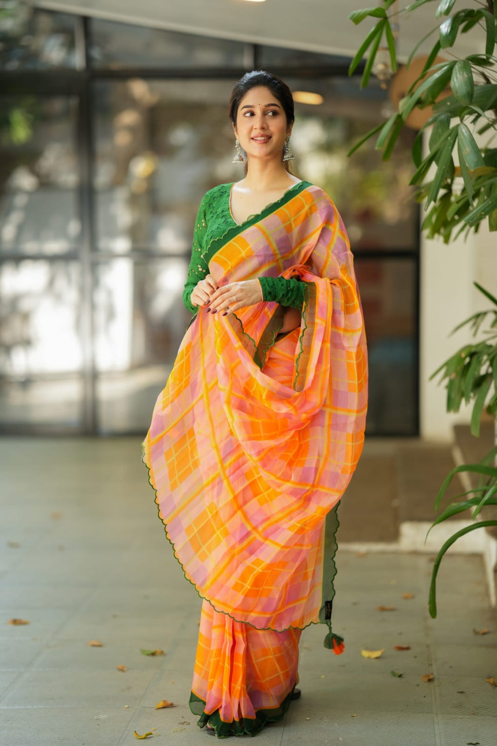 Orange viscose jute saree with green hakoba blouse