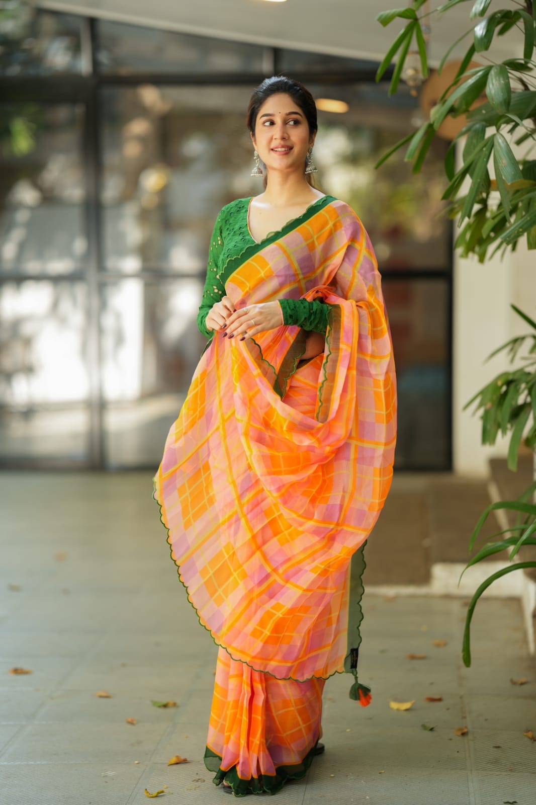 Orange viscose jute saree with green hakoba blouse
