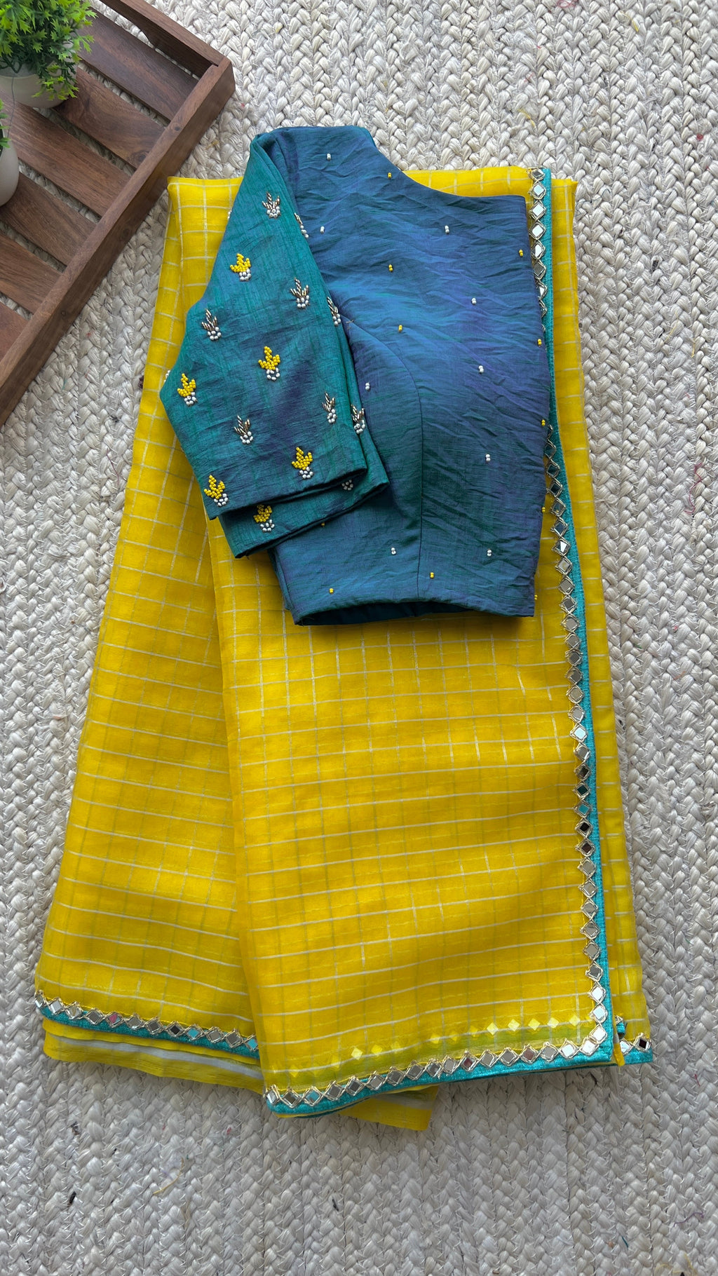 Yellow organza checked saree with handwork blouse