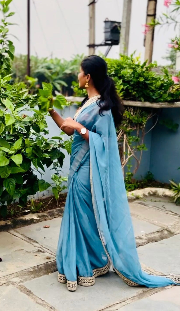 Blue organza saree with stripe velvet blouse