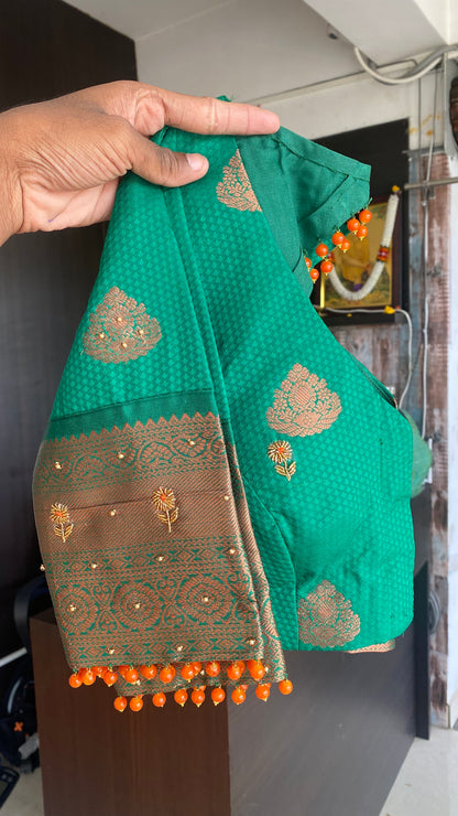 Orange and green silk saree with hand work blouse