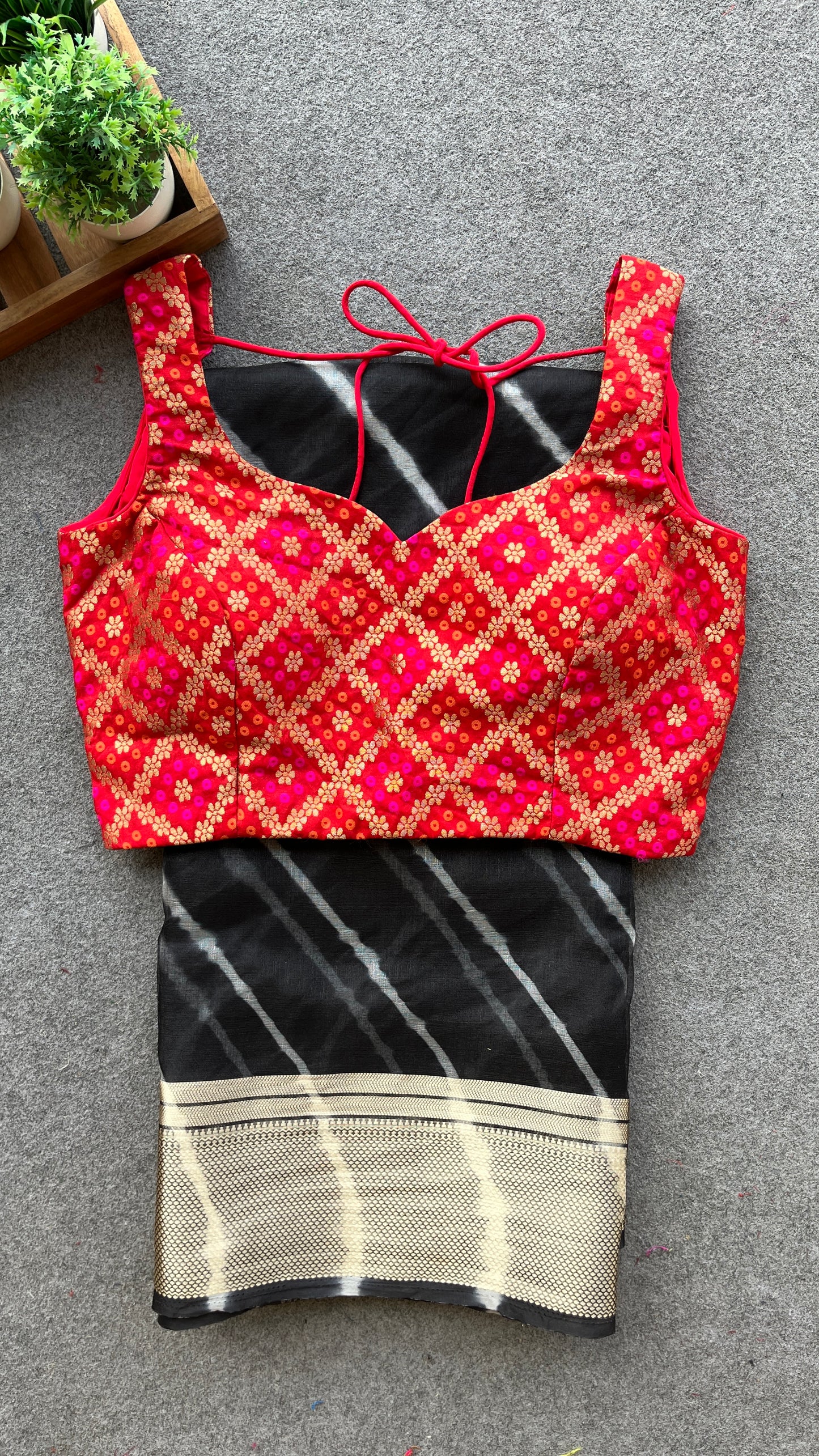 Black organza saree with red bandhini blouse