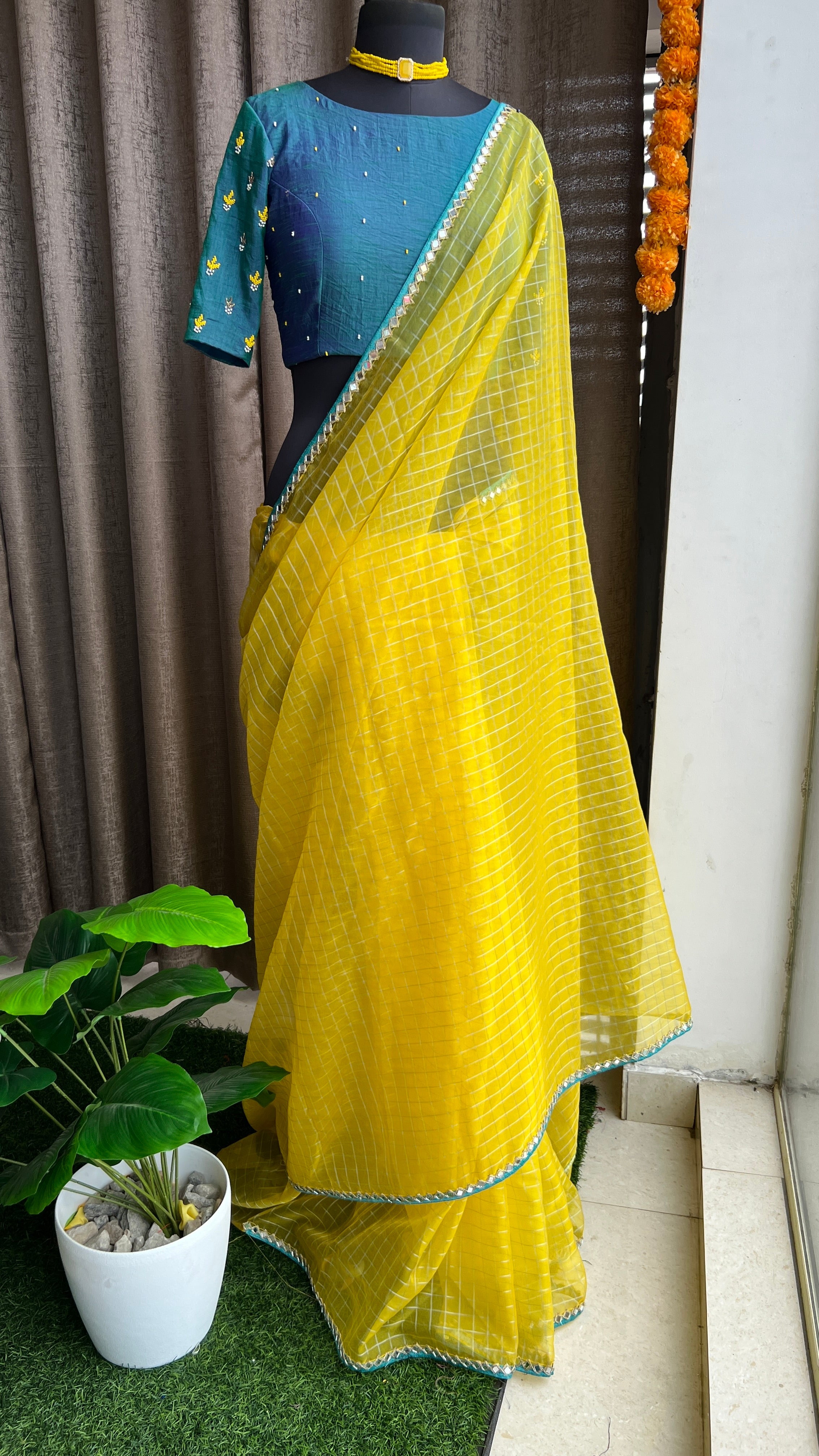 Yellow organza checked saree with handwork blouse