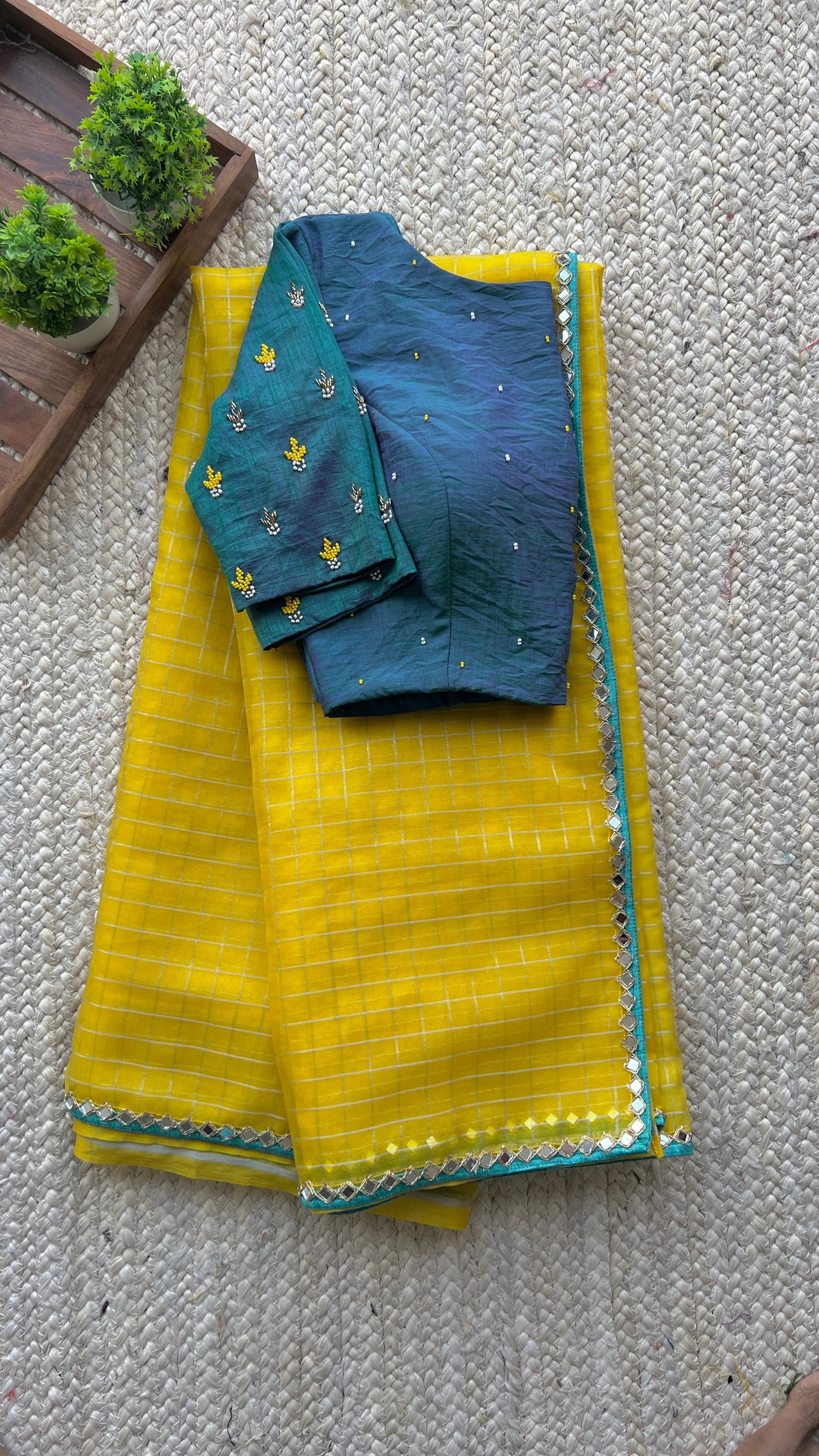 Yellow organza checked saree with handwork blouse