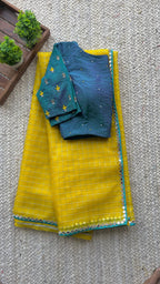 Yellow organza checked saree with handwork blouse