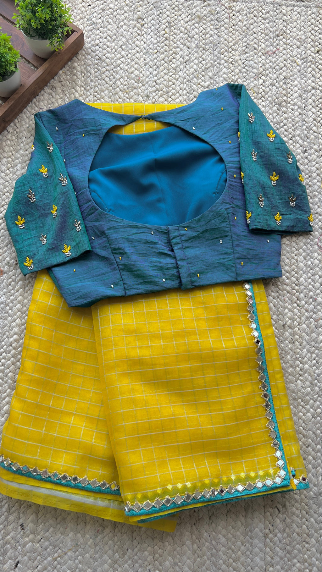 Yellow organza checked saree with handwork blouse