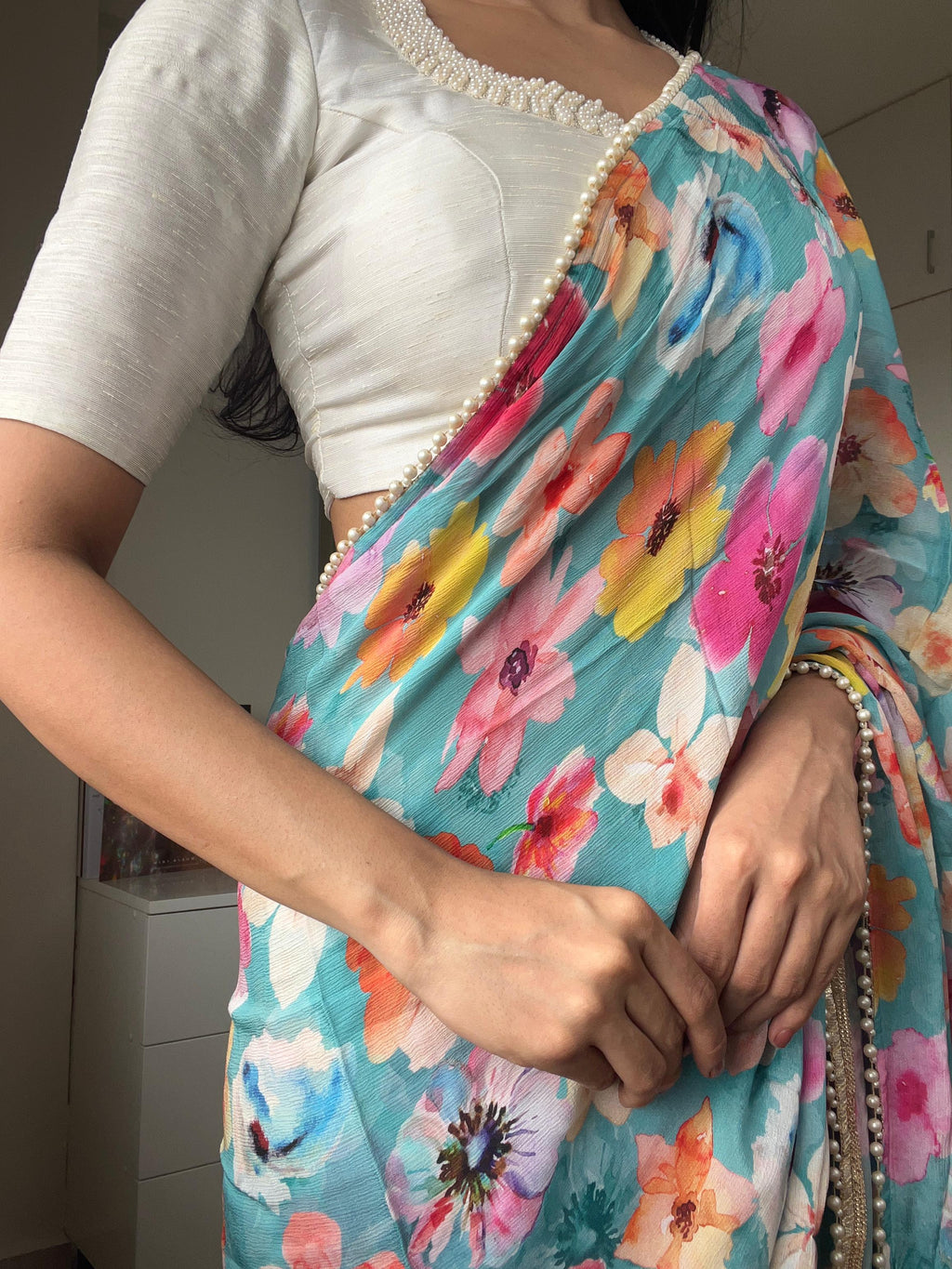 Blue floral chinnon saree with pearl hand work blouse