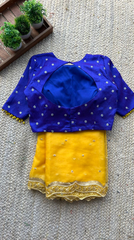 Yellow organza saree with purple hand work blouse