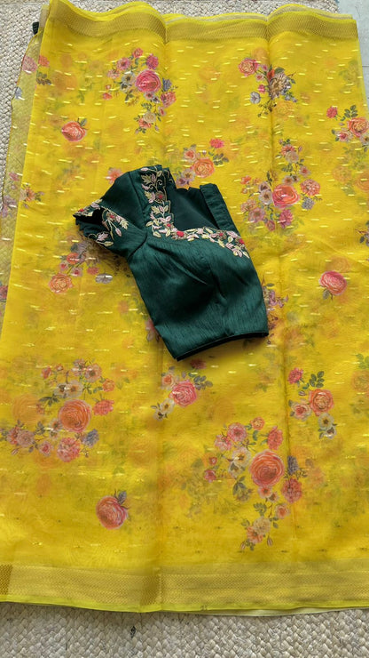 Yellow organza saree with green handwork blouse