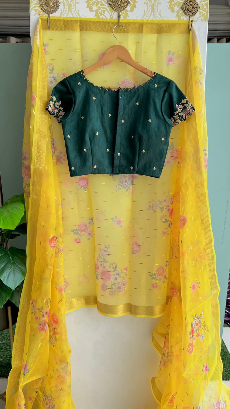 Yellow organza saree with green handwork blouse