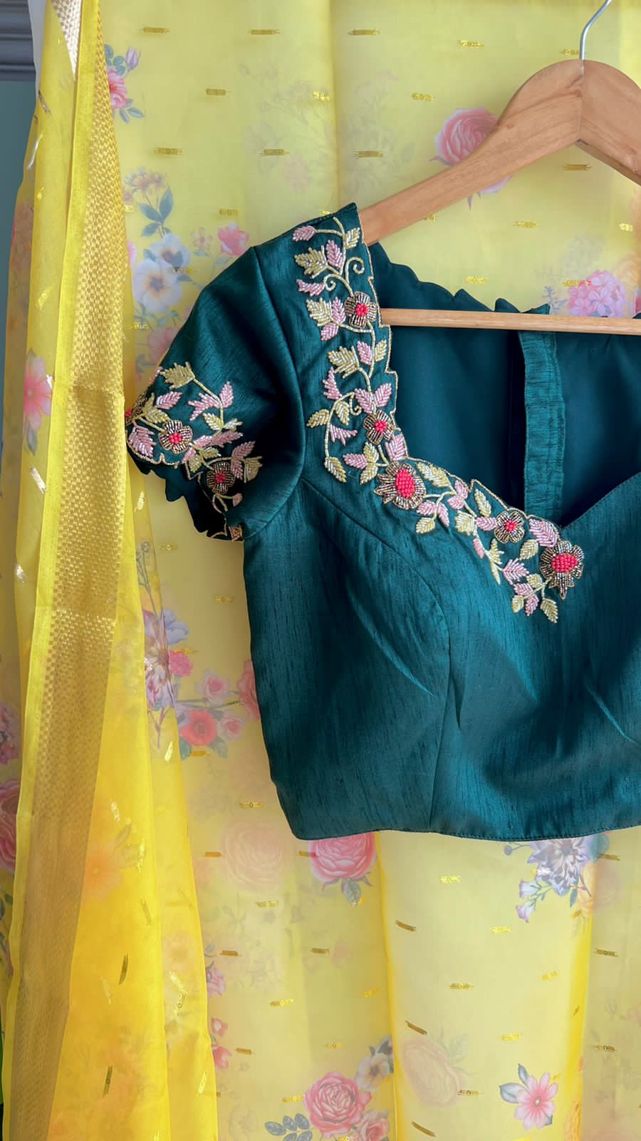 Yellow organza saree with green handwork blouse