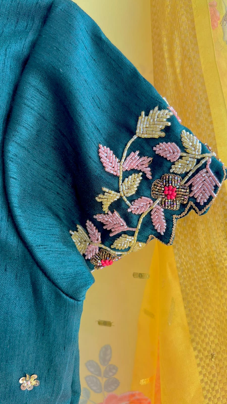 Yellow organza saree with green handwork blouse