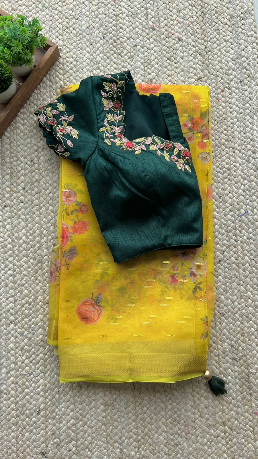Yellow organza saree with green handwork blouse