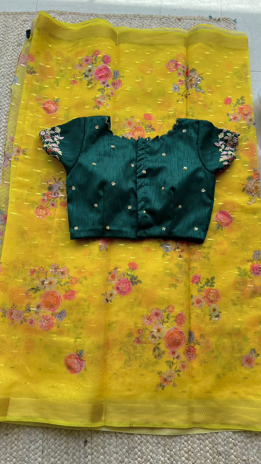 Yellow organza saree with green handwork blouse