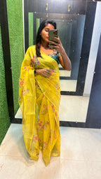 Yellow organza saree with green handwork blouse