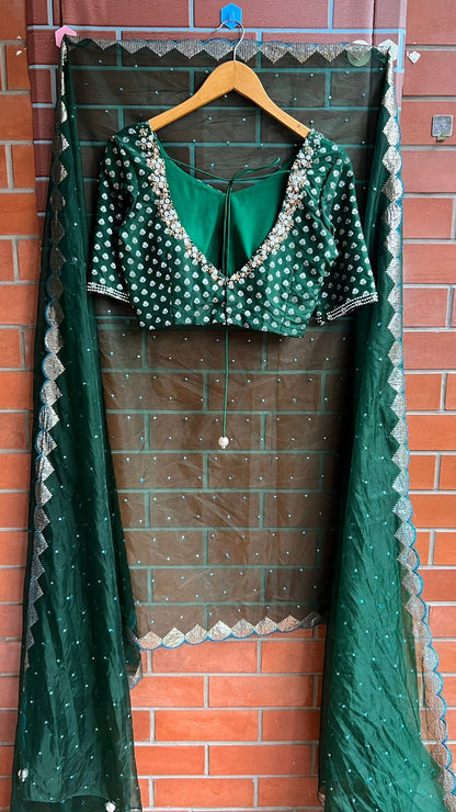 Bottle green organza saree with banarasi handwork blouse