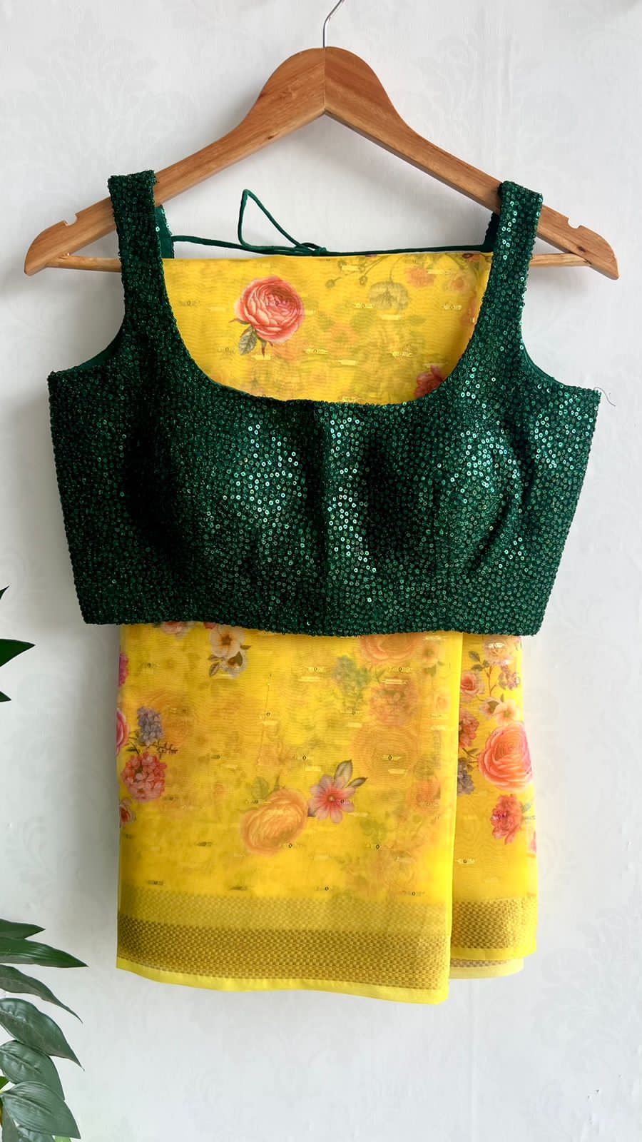 Yellow organza saree with green sequins blouse