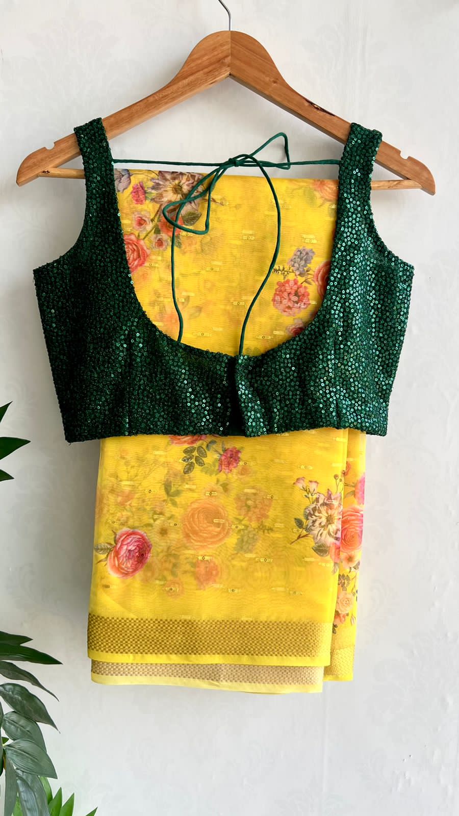 Yellow organza saree with green sequins blouse