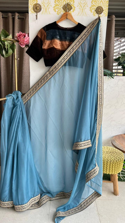 Blue organza saree with striped velvet blouse