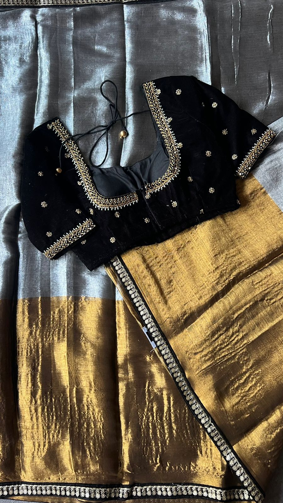 Silver tissue saree with black velvet hand worked blouse