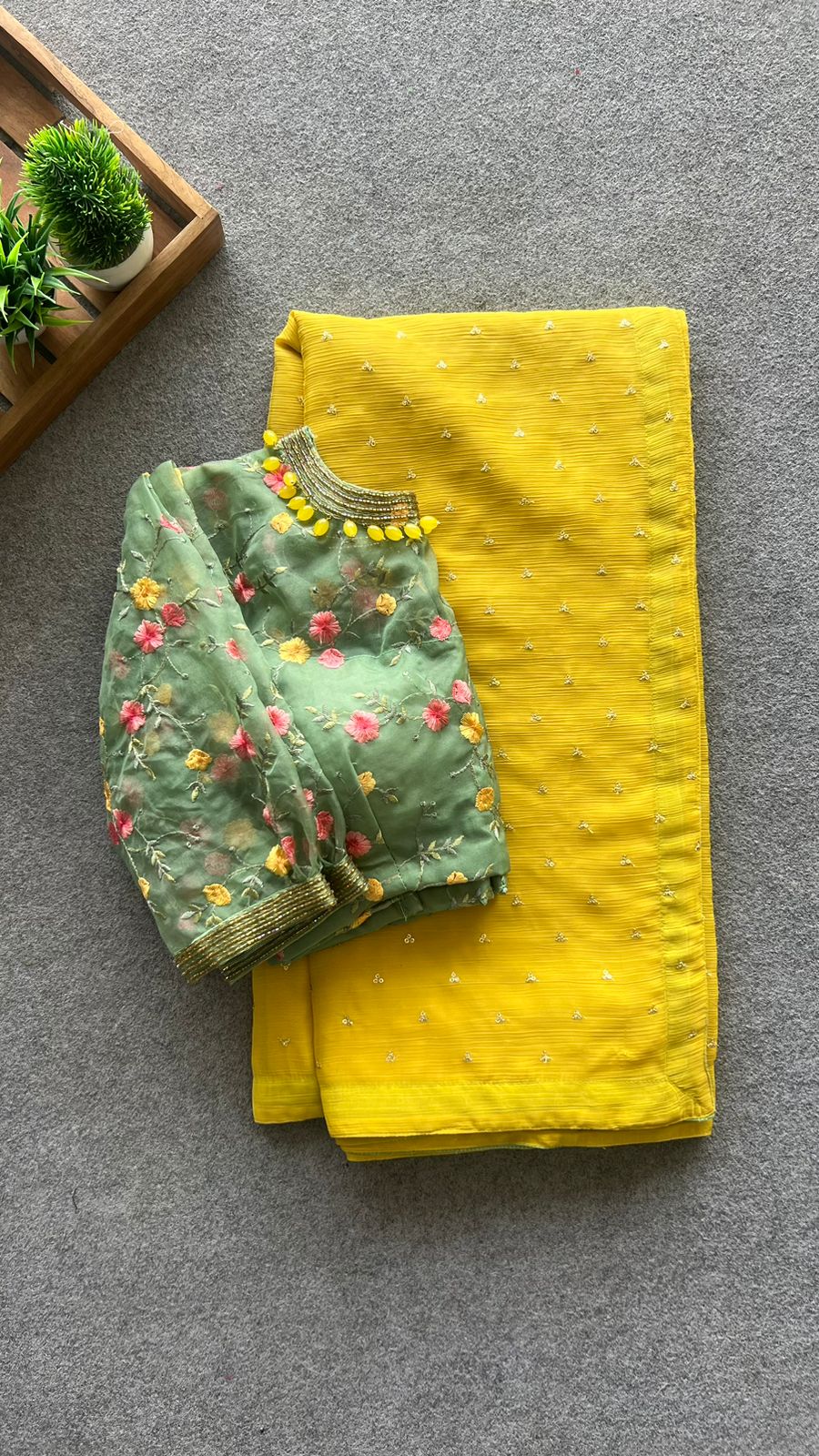 Yellow chiffon saree with green hand worked blouse