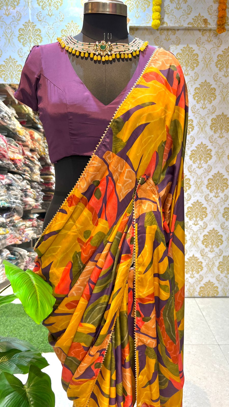 Yellow floral satin saree with purple jewel neck hand work blouse
