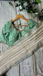 Beige silk designer saree with pista green embroidered blouse