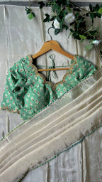 Beige silk designer saree with pista green embroidered blouse