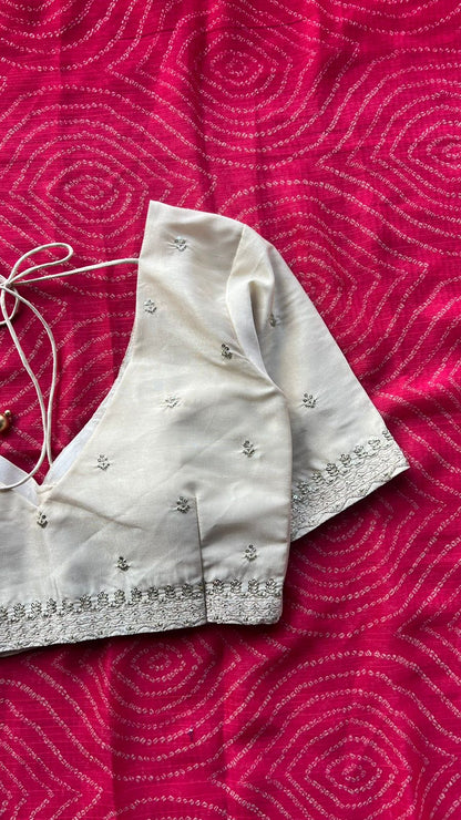 Pink chiffon bandhini saree with white embroidered blouse