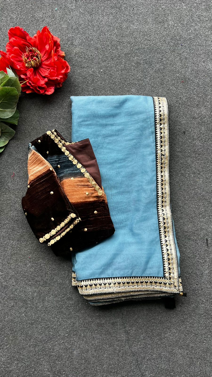 Blue organza saree with stripe velvet blouse
