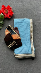 Blue organza saree with stripe velvet blouse
