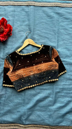 Blue organza saree with stripe velvet blouse