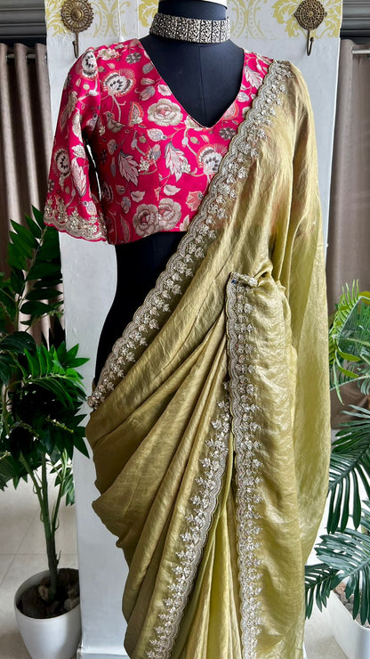 Green soft tissue saree with pink floral embroidered blouse