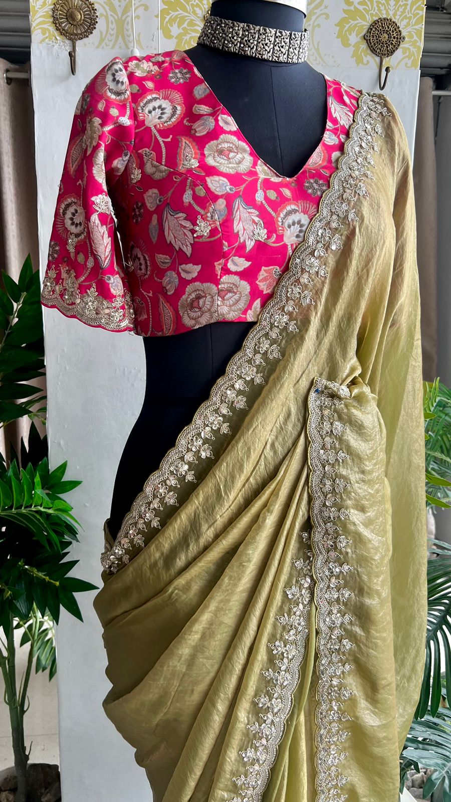 Green soft tissue saree with pink floral embroidered blouse