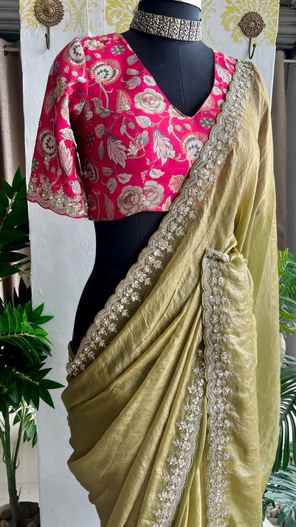 Green soft tissue saree with pink floral embroidered blouse