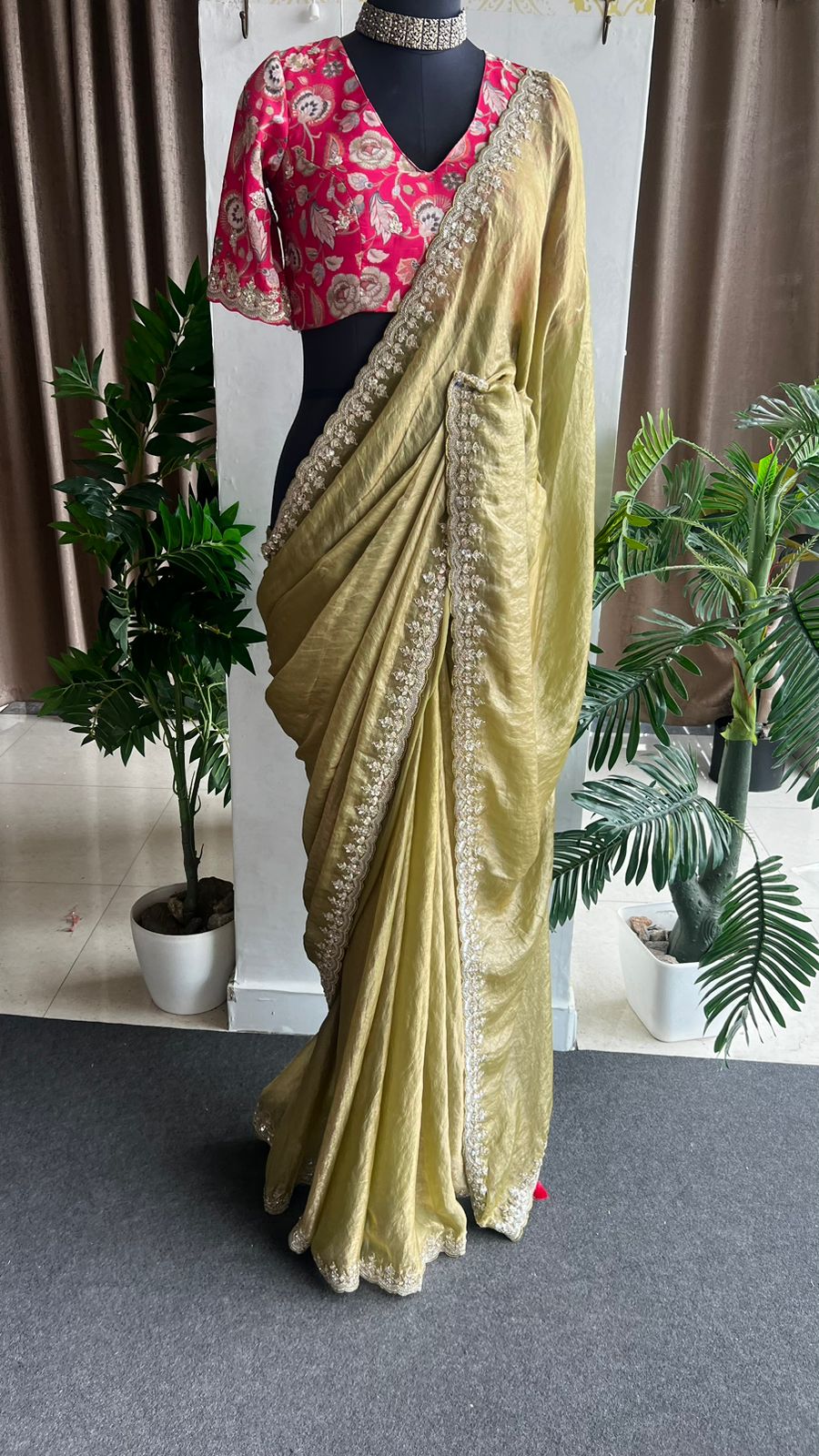 Green soft tissue saree with pink floral embroidered blouse