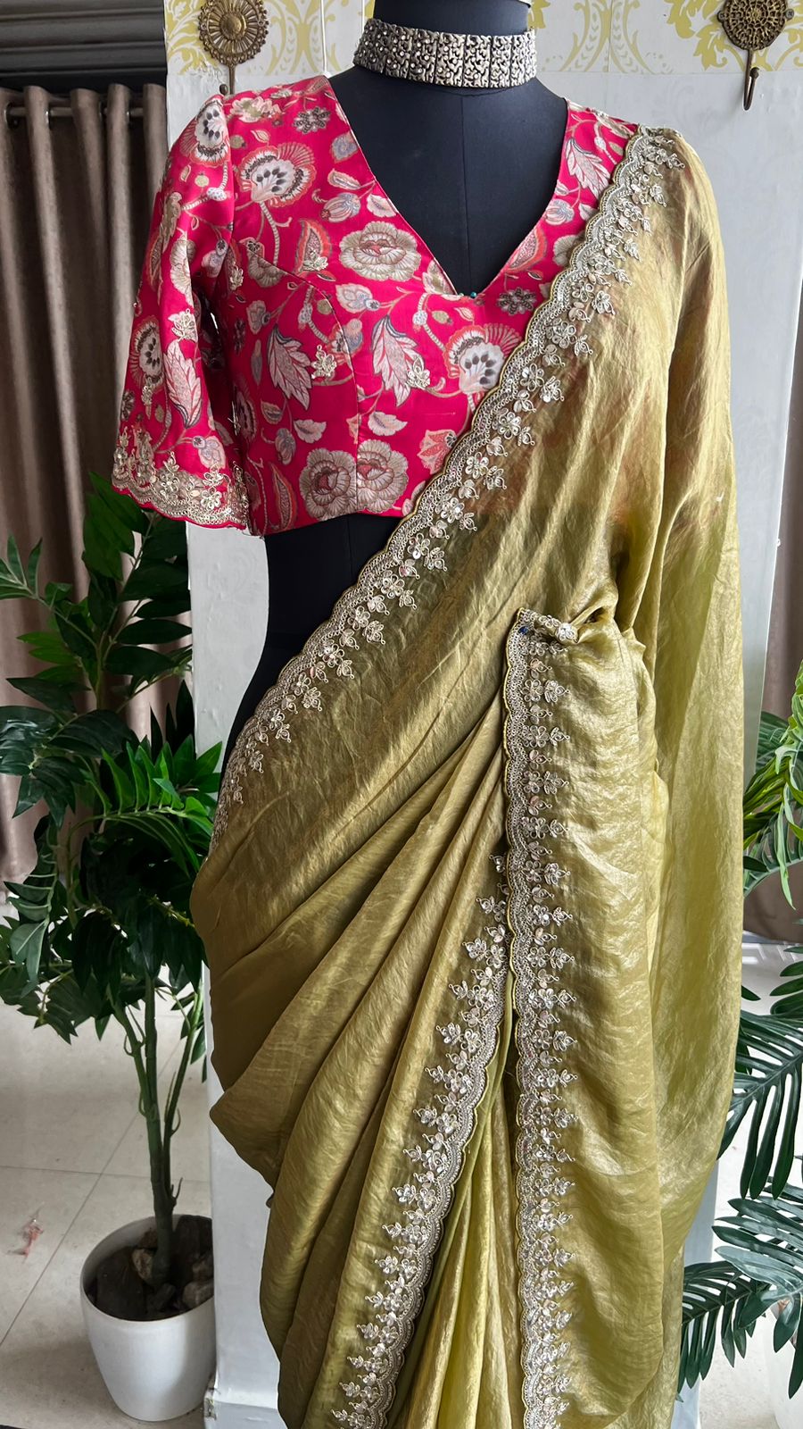 Green soft tissue saree with pink floral embroidered blouse